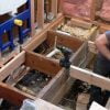 Reinforcing floor joists with solid wood blocking.