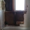 Demolition of old bathroom and shower tile and walls. Notice improper use of gypsum drywall as tile backer board.