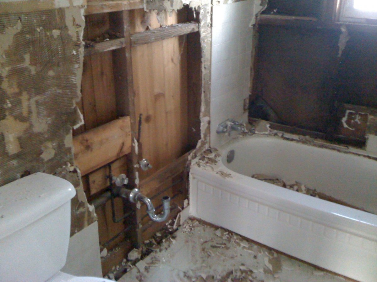 Demolition of old bathroom walls, tile and tub.