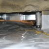 Vapor barrier sealed around block support and plumbing penetration.
