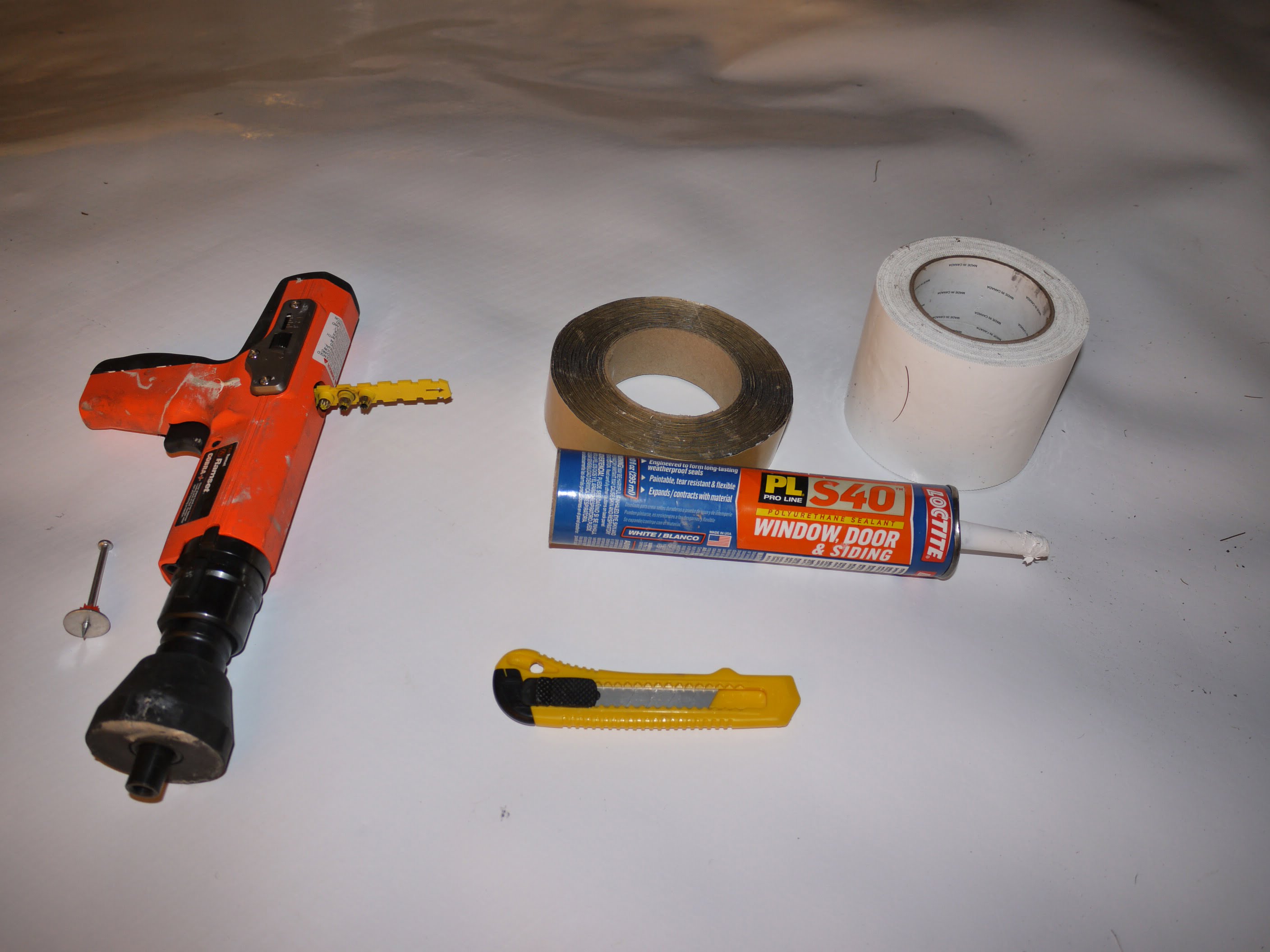 Tools and supplies used to mount vapor barrier to my spray foam foundation walls.