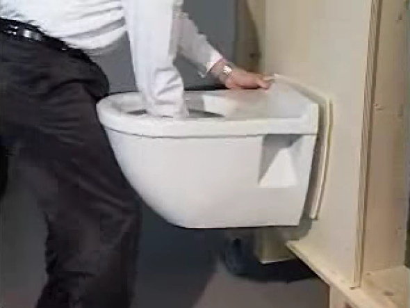 Install the wall-mounted toilet after aligning the toilet bowl with the wall plumbing connections. 