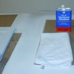 Microfiber cloth and denatured alcohol used to clean cabinet doors after sanding of primer coat.