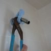 Tighten shower arm with wrench protected with a folded rag.