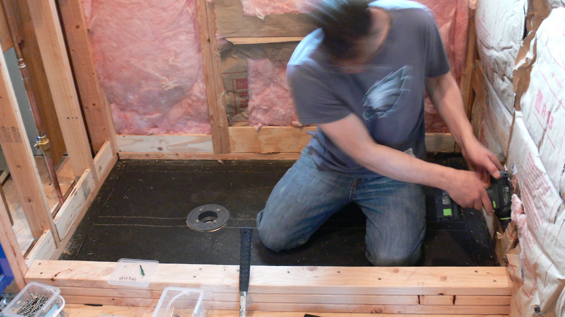 Build a shower curb frame using stacked 2 x 4s. Add blocking between wall studs to form shower pan "box".