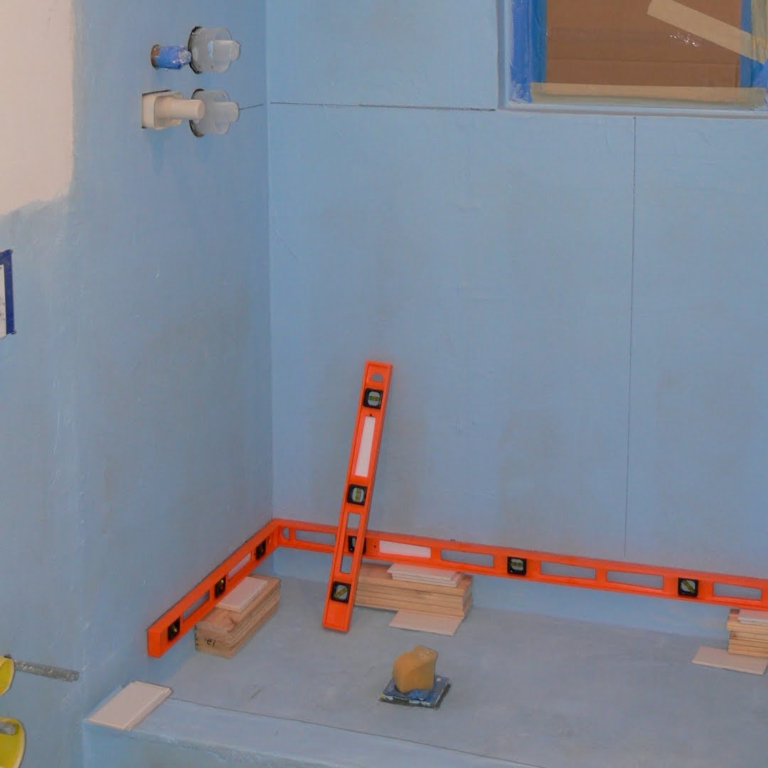 Hydro Barrier paint-on rubber polymer waterproofing applied to tile backer board prior to installing shower tile.