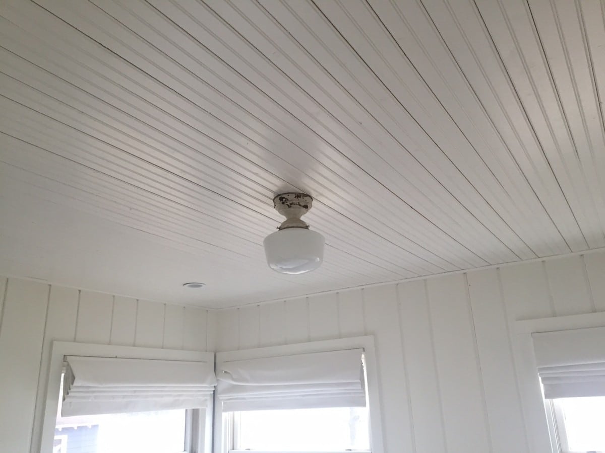 White painted beadboard ceiling in bedroom.