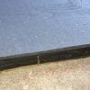 Align bottom edge of skirt board with bottom edge of rain screen mat.