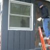 Boards installed around window for board and batten siding.