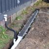 Installation of channel drain system (Dura Slope by NDS) for in-ground gutter system.