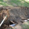 Install drain pipe for discharge circuit, then replace dirt to fill trench.