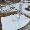 Fiberglass jacket insulation placed over septic tank cover.