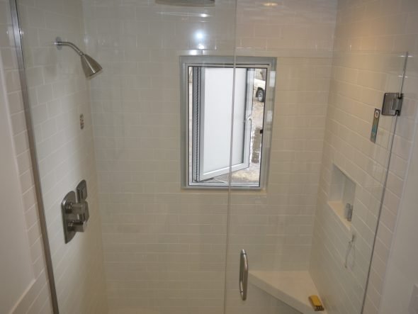 Walk-in tile shower showing finished diy tile shower niche.
