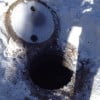 Sepic tank cover removed on frozen septic system.