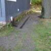 Grass seeding over and around surface yard drain for in-ground gutter system