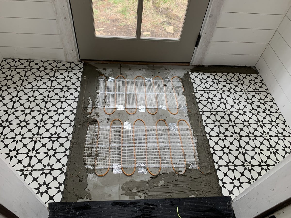 Electric in-floor electric heating mat installed under entryway tile flooring.