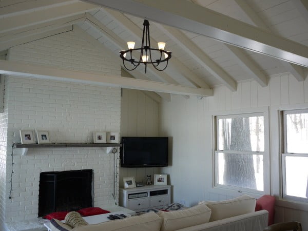 Painted interior wood paneling, ceiling, beams and fireplace complete.