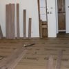 Rack hardwood flooring behind install row to help plan visual layout, seams and to speed install.