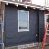 Roofing felt used as weather-resistant barrier for rainscreen wall build.