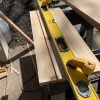Rip cedar boards for wine cellar using another board clamped as a saw guide.