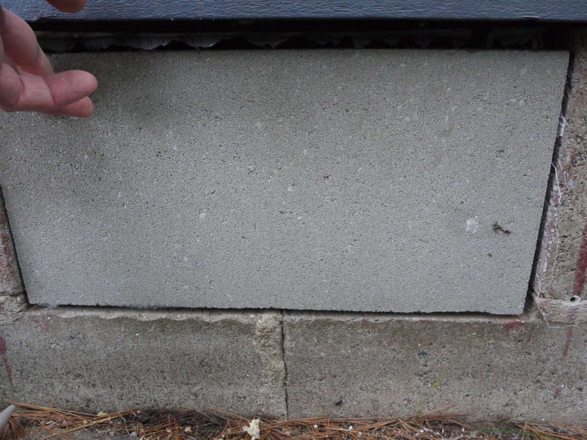 Crawl space vent holes sealed with concrete block and polyurethane caulk. 