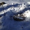 Frozen septic system tank cover after digging out with cover lifted.