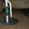 Sump pump and sump basin install in a crawl space.