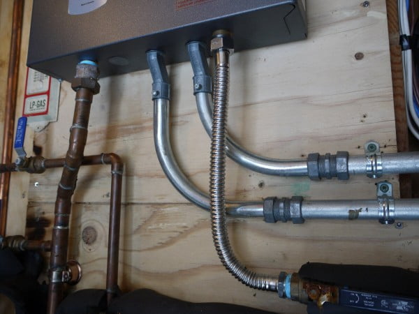 Tankless water heater plumbing supply connection with flexible stainless steel connection.