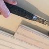 Tighten tongue and groove beadboard ceiling boards using a hammer and scrap piece of tongue and groove board.