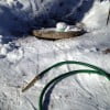 Garden hose with nozzle ready for passing into septic line.