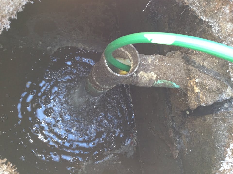 Flushing frozen septic line - garden hose passed into septic line with water source turned on.