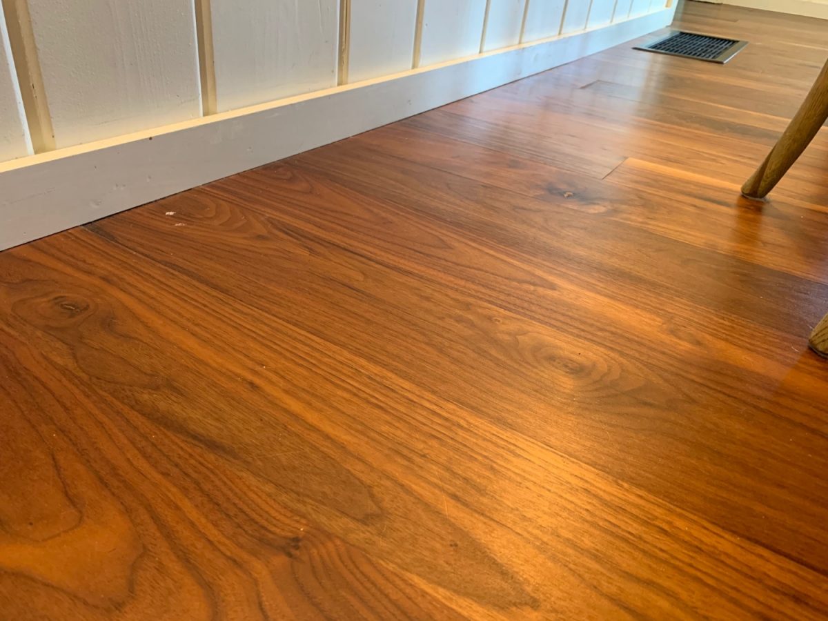 Closeup of wide plank american walnut engineered hardwood flooring install in our Minnesota lake cabin.