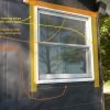 Windows flashed with peel and stick flashing tape prior to installing window trim.